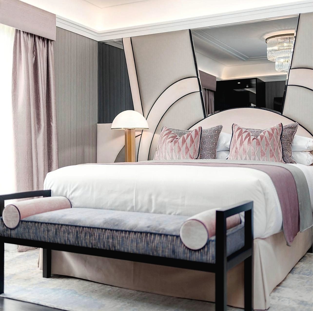 Bedroom with curved headboard and pink and grey scheme
