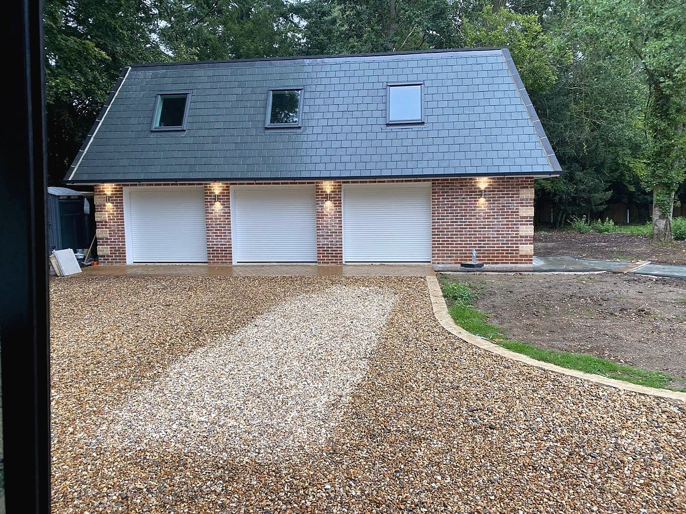 New three bay garage block in brick with a slate roof