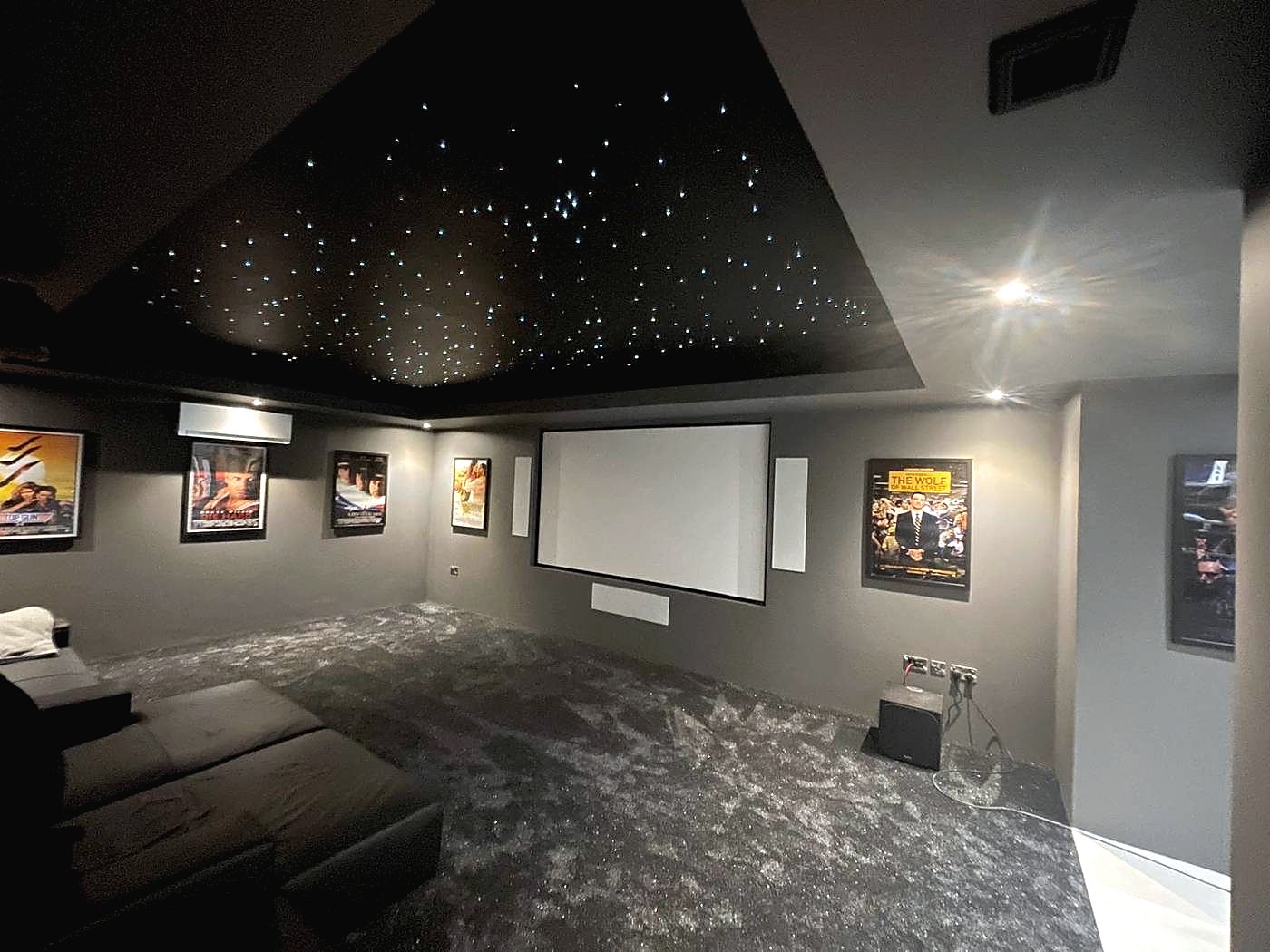 Home cinema with fibre optic star ceiling and framed film posters